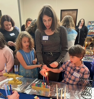 A family celebrating Hanukkah at Temple Sinai